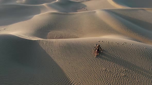 Woman is Posing in the Middle of the Desert Lying on Sand Great Sandy Desert alt