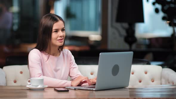 Smiling Pensive Freelancer Woman Working Remotely Use Laptop at Cafeteria alt
