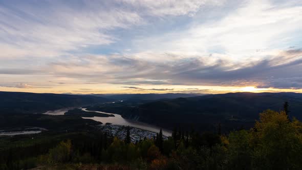 Time Lapse, View of Dawson City Lights from above at Sunset. Aerial Drone Shot. Taken from Midnight Dome Viewpoint, Yukon, Canada, Pan Down alt