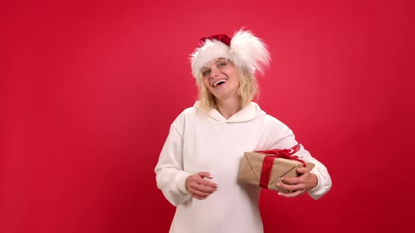 Christmas Holidays Sales and Shopping Portrait of Cheerful Woman in Santa Hat with Present Box Ask alt