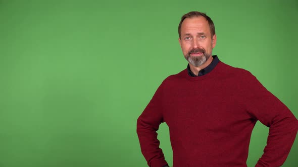 A Middleaged Caucasian Man Motions to the Camera in a Gesture of Invitation  Green Screen