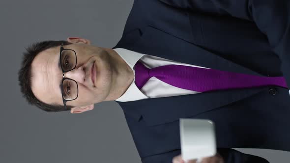 Vertical Shot Handsome Confident Middle Aged Man Holding Cup of Coffee and Looks at Camera