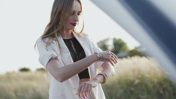 Desperate Woman Tries to Repair a Breakage Car Out of the City alt