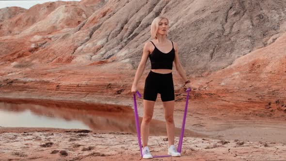 Woman working out on lifeless dried locality