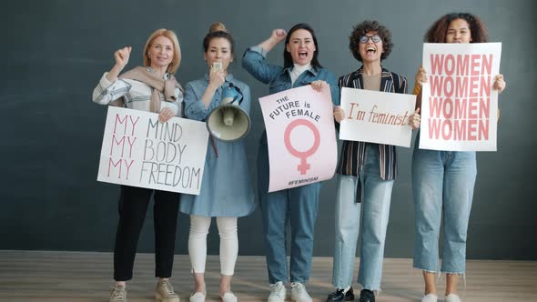 Portrait of Women Feminists Holding Gender Equality Posters and Screaming in Megaphone alt