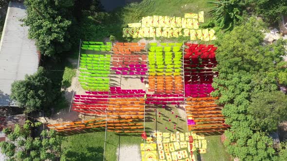 Aerial view of a man hanging colourful cloth in Araihazar, Dhaka, Bangladesh. alt