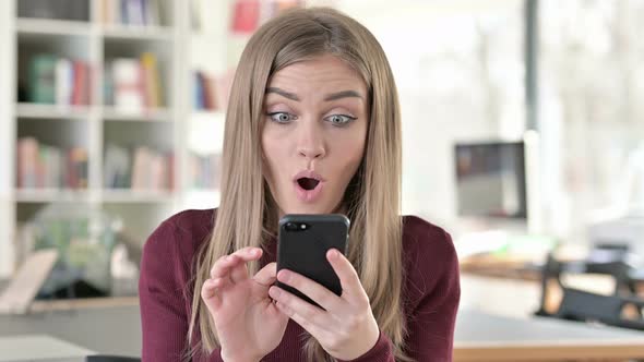 Portrait of Young Woman Celebrating on Smartphone alt