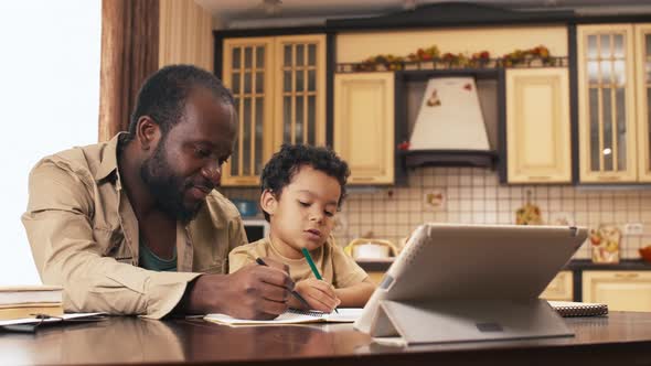 Happy man teaching his son to draw hand in hand