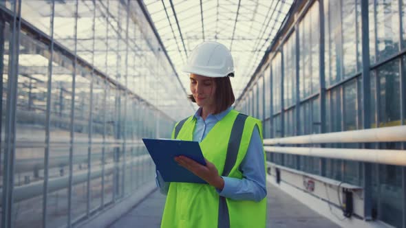 Woman Factory Specialist Noting Important Manufacture Data Analysing Information alt