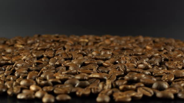 Rotation close-up of coffee beans 360. Golden selected aromatic beans rotates alt