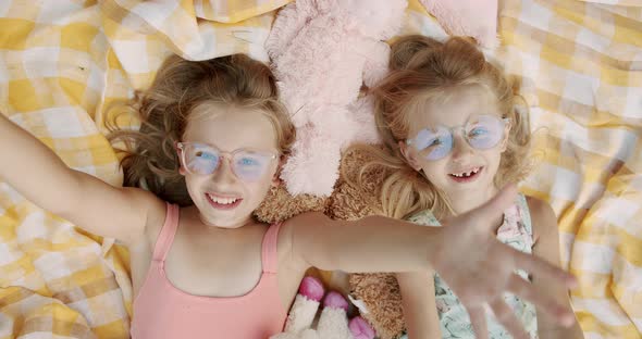 Unexpected Surprise Little Girls Smiling with Glasses Looks to Camera Holidays alt