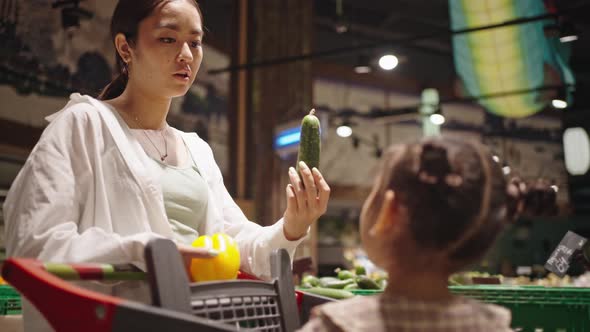 Mother Goes Shopping with Daughter Talking About Products alt