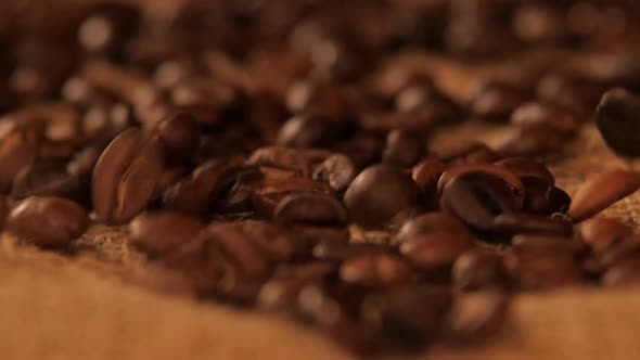 Falling Brown Coffee Beans on Sacking, Close Up alt
