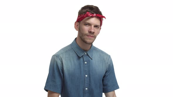 Attractive Bearded Male Hipster Wearing Red Hiphop Bandana Smiling Sassy and Pointing Fingers at