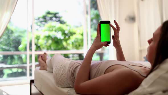Woman Lying on Bed with Smartphone Alpha Channel