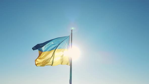 Ukraine Flag On A Background Of Blue Sky And Sun