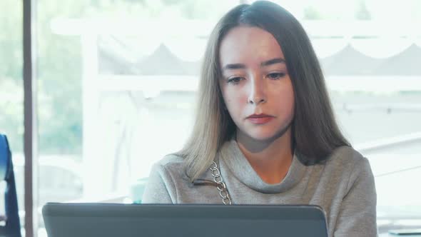 Beautiful Woman Looking Stressed While Working on Laptop