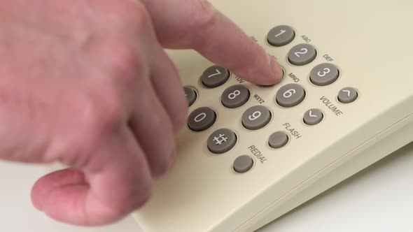 Hand Picks Up the Phone Dials the Number , Old Push-button Office Phone on White Background. Close