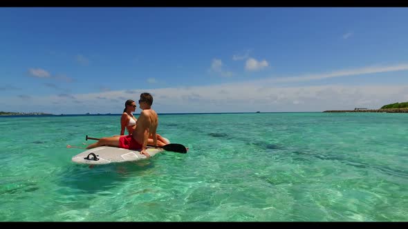 Teenage lovers posing on exotic bay beach adventure by clear lagoon with white sand background of th alt