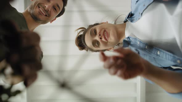 Static video of couple pulling things out of cardboard box. Shot with RED helium camera in 8K alt