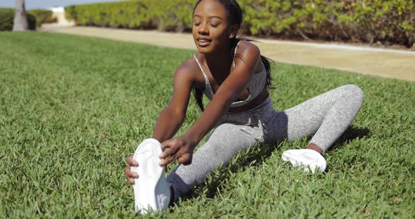 Black Woman Sitting and Stretching alt