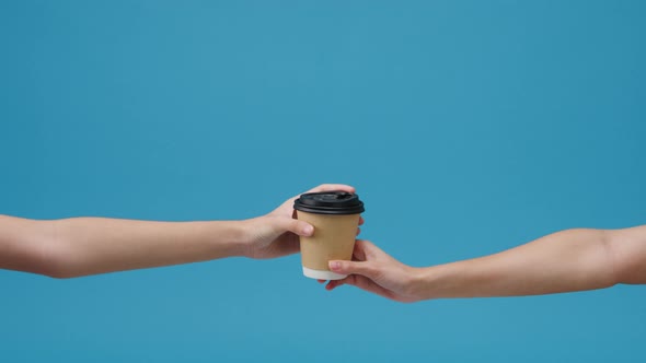 Young woman hand hold brown clear empty blank coffee paper cup for takeaway.