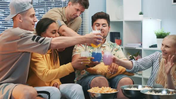 Close Up of Multiracial Guys and Girls Cheers with Each Other with Dry Ice Cocktails alt