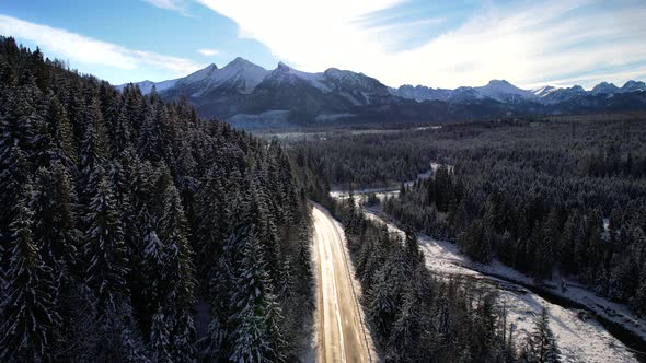 Aerial view of mountain twisted road in the winter. Epic, snowy white winter in the mountains.
