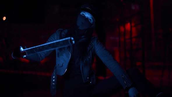 Girl in a Black Virus Mask Looks at the Camera in Blue Lights
