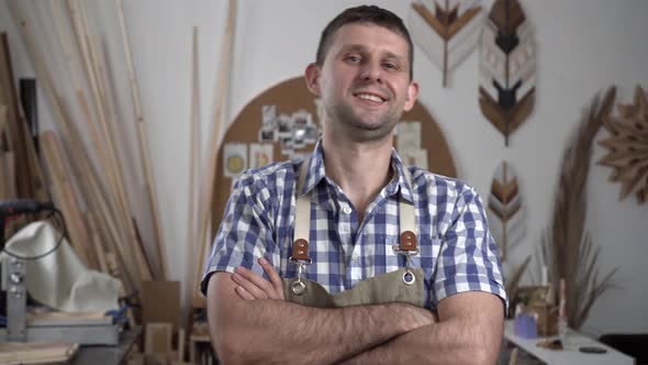 Happy Male Worker Smiling in Workshop alt
