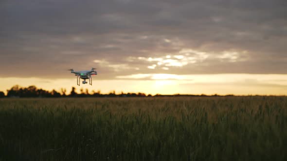 Slow Motion of Drone Flying Away Towards Sunset Evening Dusk in Rural Agricultural Area