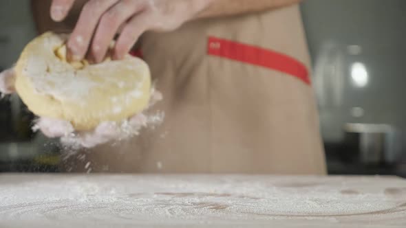 Chef Baker Man in Apron Prepares the Dough alt
