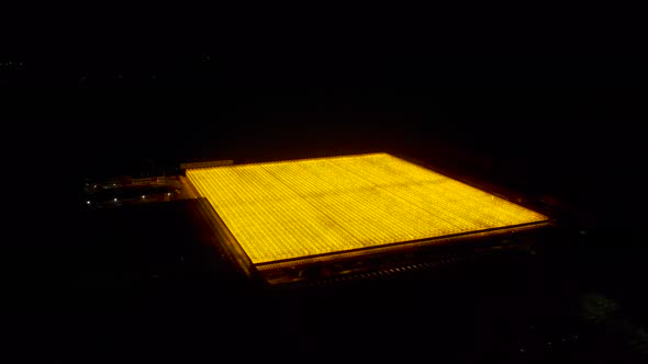 Greenhouse Rooftop Glowing at Night Aerial View