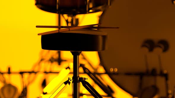 Details of drum kit on a bright yellow background. Percussion chrome hardware. alt