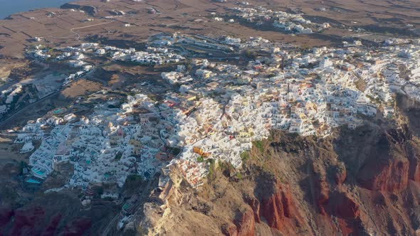 Aerial shot of famous Oia village in Santorini at sunrise in Greece
