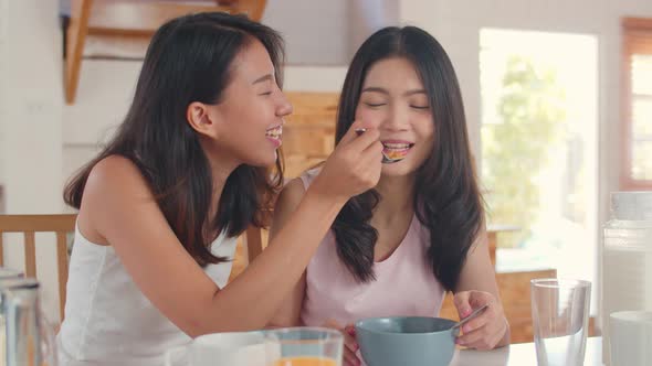 Asian Lesbian lgbtq women couple have breakfast at home. alt
