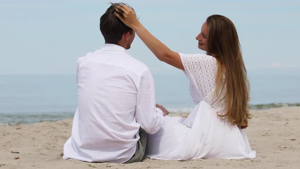 Sweet Couple in White Clothes Relax on The Beach