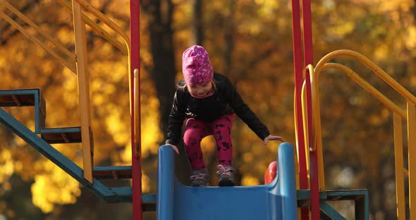 Pretty Little Girl in Black Jacket Smiles and Rejoices in the Autumn Park