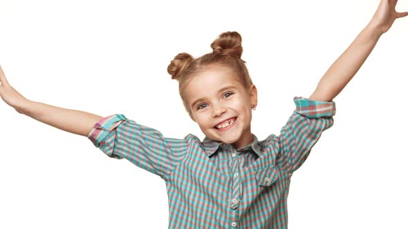 Beautiful Charming Young Caucasian Girl Kid in Plaid Shirt Jumping and Smiling on White Background alt