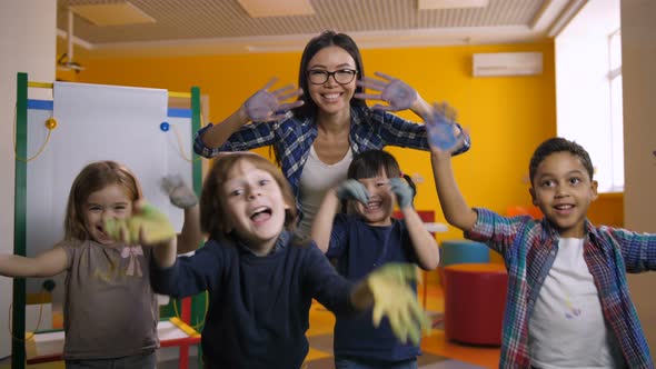 Diverse Kids Showing Hands Painted with Paint alt