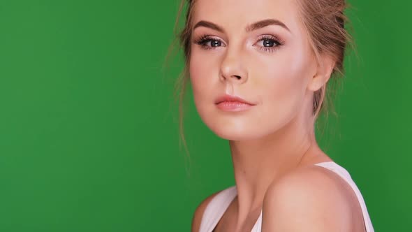 Woman with Perfect Skin Looking To the Camera and Moving with Her Head alt