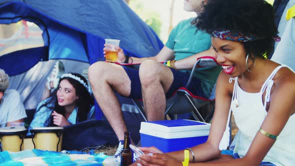 Woman using mobile phone in park 4k alt