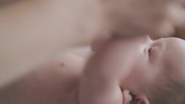 Pediatrician Flexes and Stretches Adorable Infant Boy Arms alt