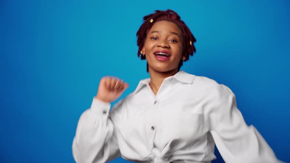 Cool Young Afro Woman Showing Thumbs Up Approves Something Blue Background