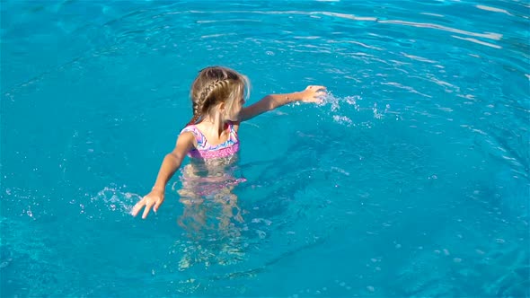 Adorable Little Girl in Outdoor Swimming Pool