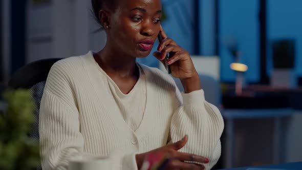 Nervous African Manager Discussing at Smartphone with Employee alt