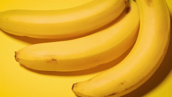 Fresh Bananas on a Yellow Minimalistic Background