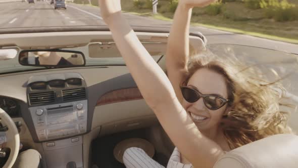 Young beautiful and smiling hipster girl in convertible car alt