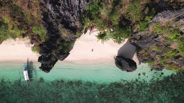 Drone Of Woman Sunbathing In Swimsuit On Entalula Beach alt