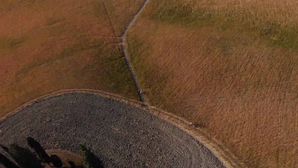 Aerial shot of people walking in the hills of Val d'orcia ,TUSCANY,ITALY alt